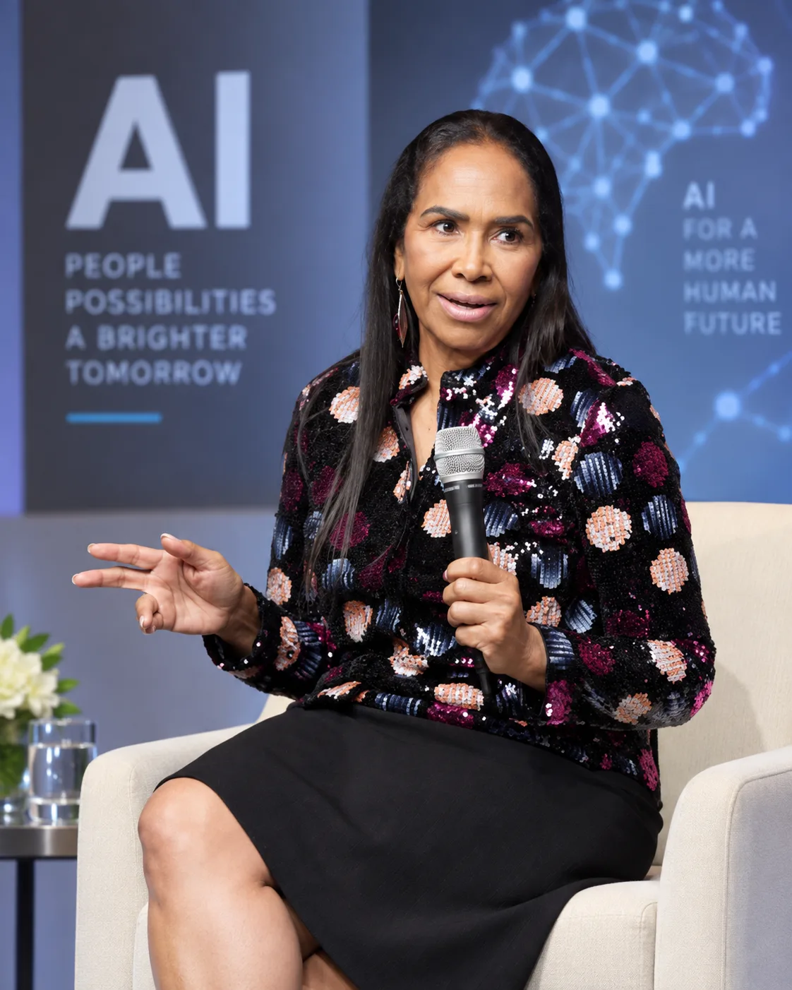 Roxanne Felton Christopher speaking on an AI panel, holding a microphone.